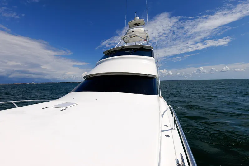On Ice Yacht Photos Pics 2009 Viking 74 Enclosed Bridge yacht cruising on open sea under blue sky.