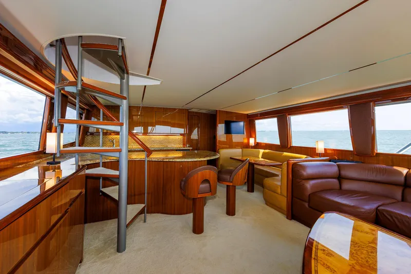 On Ice Yacht Photos Pics Luxurious interior of 2009 Viking 74 Enclosed Bridge yacht with elegant wood finishes and seating.