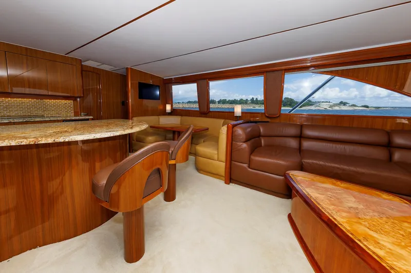 On Ice Yacht Photos Pics Luxurious interior of 2009 Viking 74 Enclosed Bridge yacht with elegant wood finishes and ocean view.