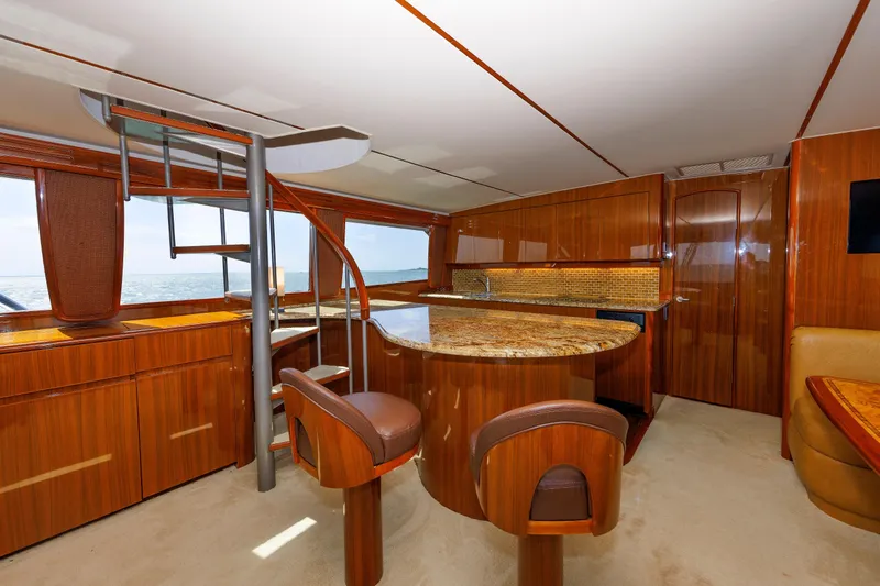 On Ice Yacht Photos Pics Luxurious interior of 2009 Viking 74 Enclosed Bridge yacht with elegant wood finishes.