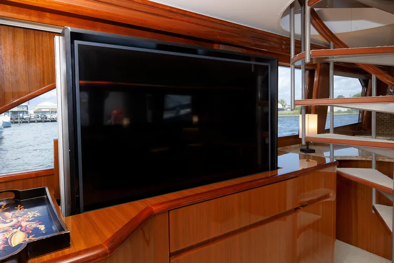 On Ice Yacht Photos Pics Luxurious interior of 2009 Viking 74 Enclosed Bridge yacht with TV and spiral staircase.