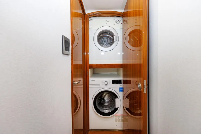 On Ice Yacht Photos Pics Laundry area with stacked washer and dryer in 2009 Viking 74 Enclosed Bridge yacht.
