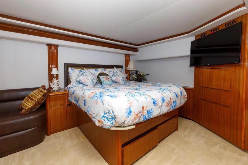 On Ice Yacht Photos Pics Luxurious bedroom in 2009 Viking 74 Enclosed Bridge yacht with elegant wood finishes.