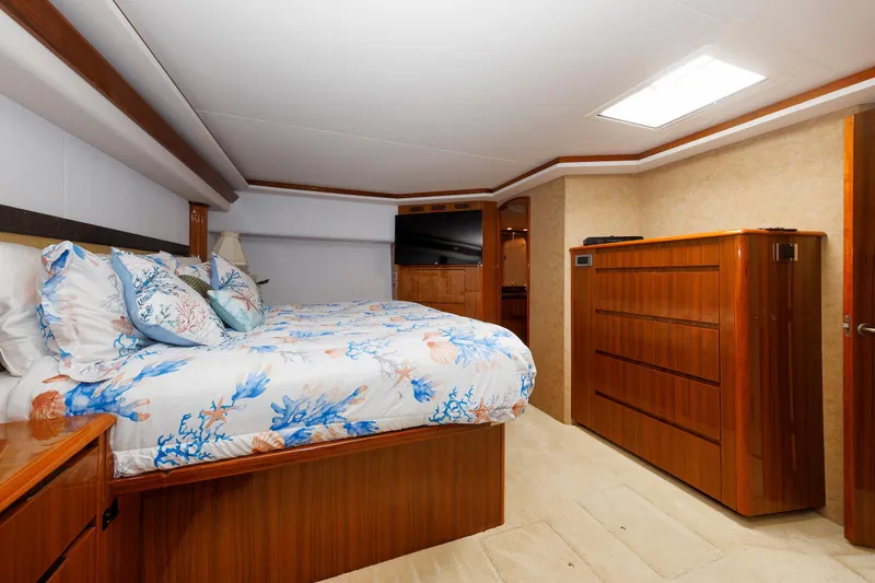 On Ice Yacht Photos Pics Luxurious bedroom interior of 2009 Viking 74 Enclosed Bridge yacht with elegant wood furnishings.