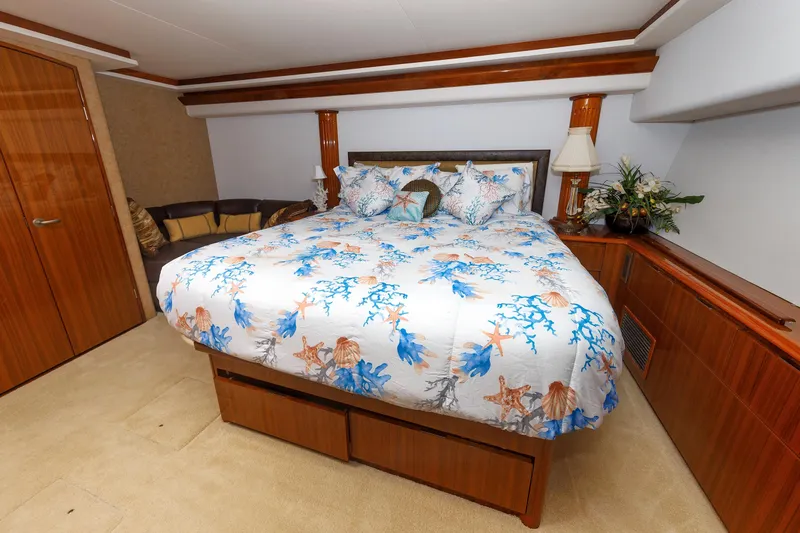 On Ice Yacht Photos Pics Luxurious bedroom in 2009 Viking 74 Enclosed Bridge yacht with nautical-themed bedding.