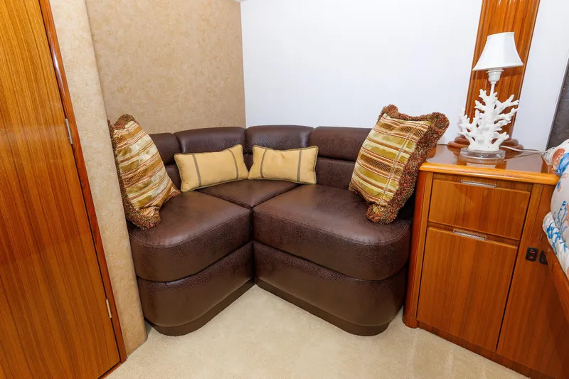 On Ice Yacht Photos Pics Luxurious 2009 Viking 74 Enclosed Bridge interior with plush seating and decorative pillows.