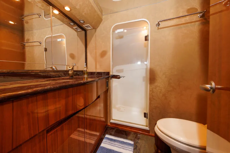 On Ice Yacht Photos Pics Luxurious bathroom in 2009 Viking 74 Enclosed Bridge yacht with elegant wood finishes.