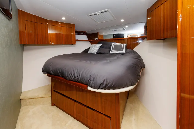 On Ice Yacht Photos Pics Luxurious bedroom interior of 2009 Viking 74 Enclosed Bridge yacht with wood cabinetry.