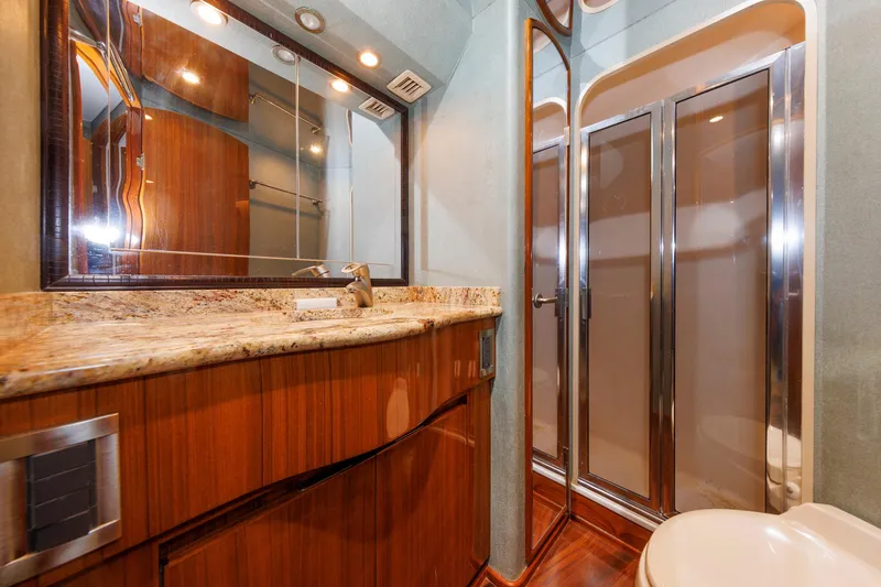 On Ice Yacht Photos Pics Luxurious bathroom in 2009 Viking 74 Enclosed Bridge yacht with wood accents and modern fixtures.