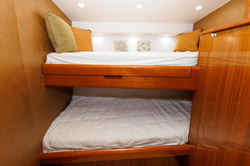 On Ice Yacht Photos Pics Bunk beds in 2009 Viking 74 Enclosed Bridge yacht cabin with wooden finish.