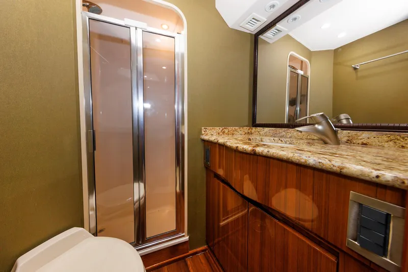 On Ice Yacht Photos Pics Luxurious bathroom in 2009 Viking 74 Enclosed Bridge yacht with granite countertop and shower.