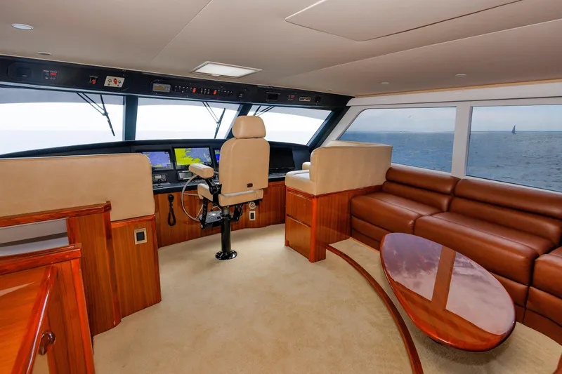 On Ice Yacht Photos Pics Luxurious interior of 2009 Viking 74 Enclosed Bridge yacht with leather seating and navigation controls.