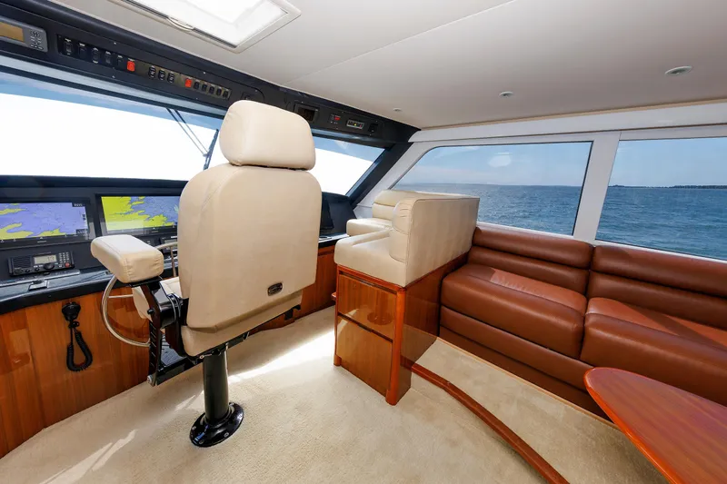On Ice Yacht Photos Pics 2009 Viking 74 Enclosed Bridge yacht interior with leather seating and navigation equipment.