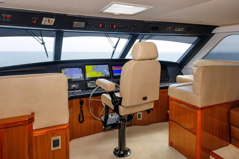 On Ice Yacht Photos Pics 2009 Viking 74 Enclosed Bridge yacht helm with navigation screens and luxurious seating.