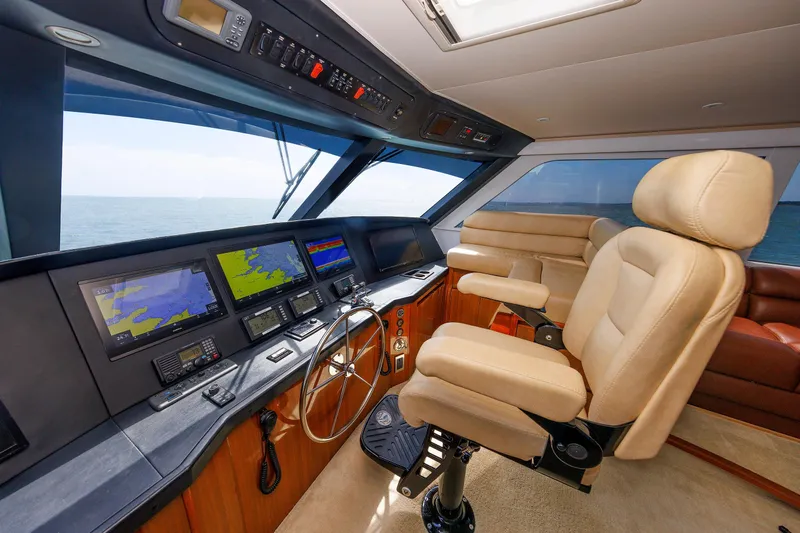 On Ice Yacht Photos Pics 2009 Viking 74 Enclosed Bridge yacht helm with navigation screens and captain's chair.