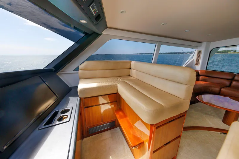 On Ice Yacht Photos Pics Luxurious interior of 2009 Viking 74 Enclosed Bridge yacht with plush seating and ocean view.