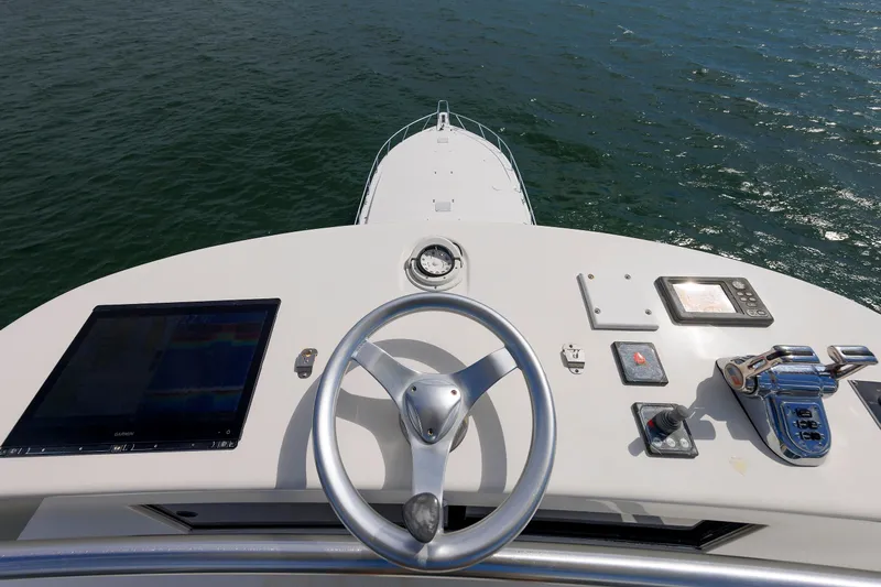 On Ice Yacht Photos Pics 2009 Viking 74 Enclosed Bridge yacht helm with navigation controls on open water.
