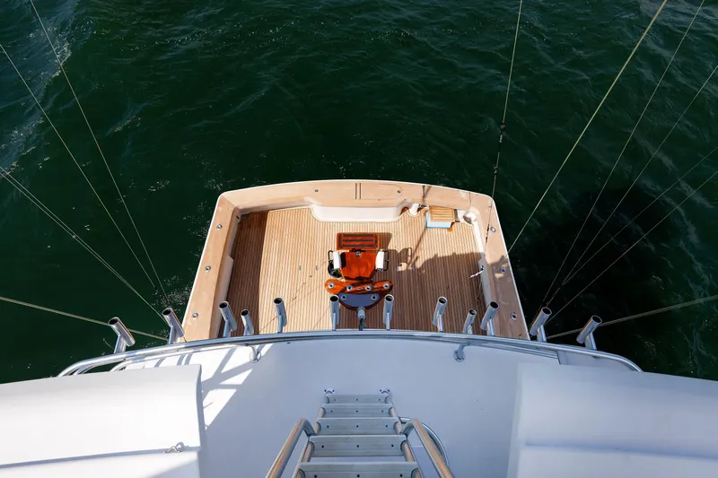 On Ice Yacht Photos Pics 2009 Viking 74 Enclosed Bridge yacht deck with fishing chair, surrounded by ocean.