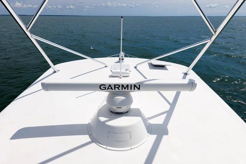 On Ice Yacht Photos Pics Bow view of 2009 Viking 74 Enclosed Bridge yacht with Garmin radar on open sea.