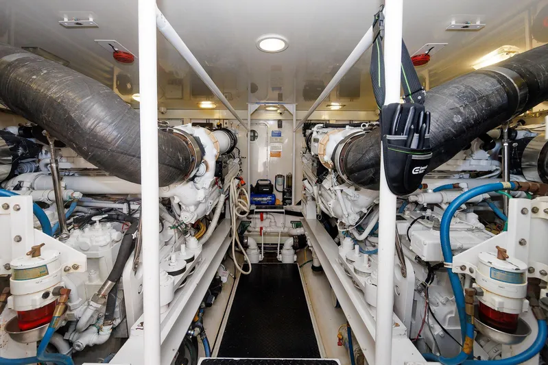 On Ice Yacht Photos Pics Engine room of 2009 Viking 74 Enclosed Bridge yacht, showcasing dual engines and mechanical systems.