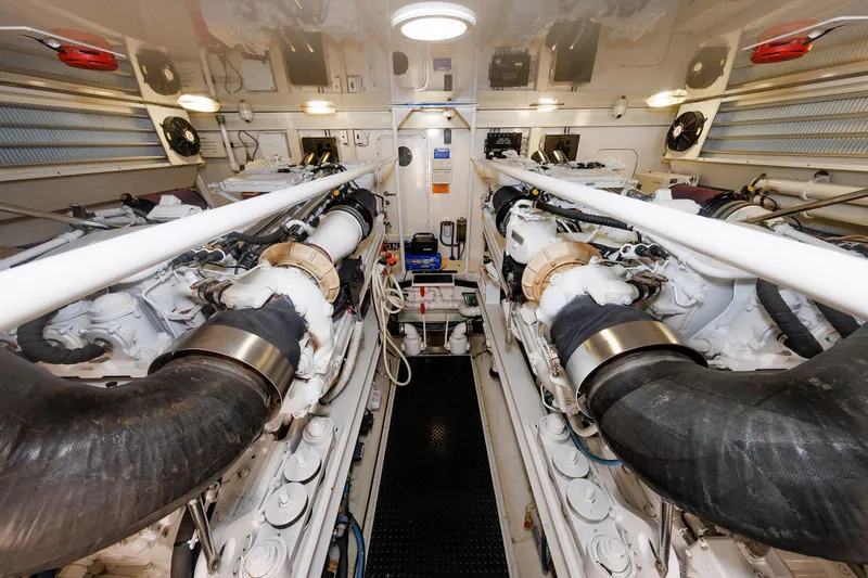 On Ice Yacht Photos Pics Engine room of 2009 Viking 74 Enclosed Bridge yacht, showcasing dual engines and mechanical systems.