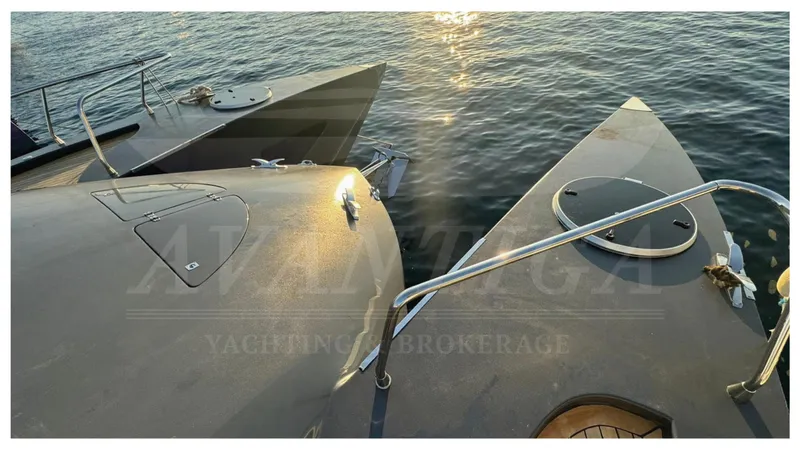  Yacht Photos Pics 2014 Catamaran Power Catamaran on water at sunset, showcasing sleek design and dual hulls.