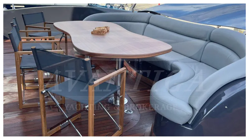  Yacht Photos Pics 2014 Catamaran Power Catamaran deck with wooden table and cushioned seating.