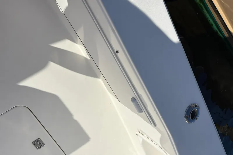 Andiamo Yacht Photos Pics 2001 Ocean 40 Express Bridge boat deck with shadows and metal fixture.