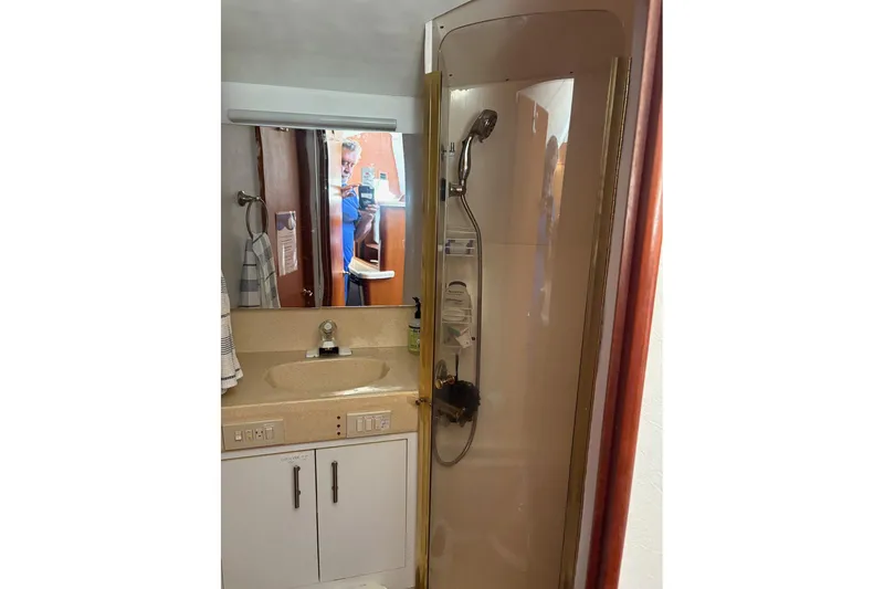 Andiamo Yacht Photos Pics Bathroom interior of 2001 Ocean 40 Express Bridge yacht with shower and sink.