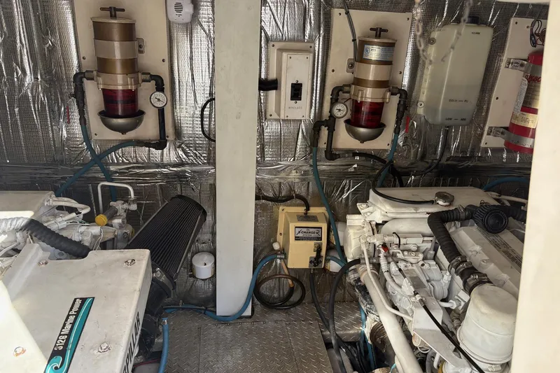 Andiamo Yacht Photos Pics Engine room of a 2001 Ocean 40 Express Bridge yacht, featuring dual engines and equipment.