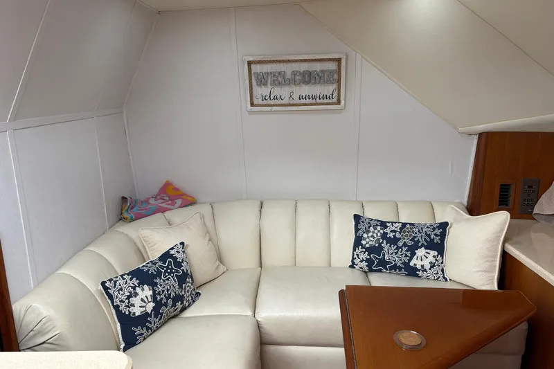 Andiamo Yacht Photos Pics Interior of 2001 Ocean 40 Express Bridge with cozy seating and decorative pillows.