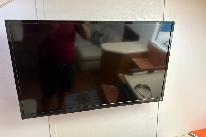 Andiamo Yacht Photos Pics Flat-screen TV on 2001 Ocean 40 Express Bridge yacht interior wall.