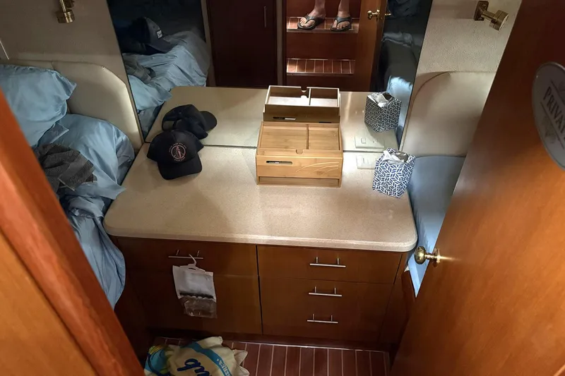 Andiamo Yacht Photos Pics 2001 Ocean 40 Express Bridge cabin interior with bed, dresser, and accessories.