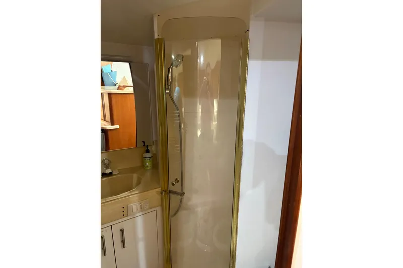 Andiamo Yacht Photos Pics Bathroom interior of 2001 Ocean 40 Express Bridge yacht with shower and sink.
