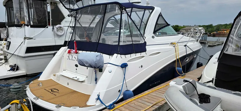  Yacht Photos Pics 2007 Rinker 350 Express yacht docked at marina, featuring sleek design and covered cockpit.