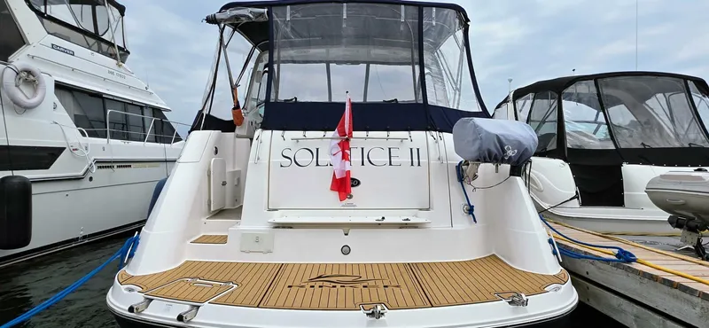  Yacht Photos Pics 2007 Rinker 350 Express yacht docked, featuring a spacious deck and Canadian flag.