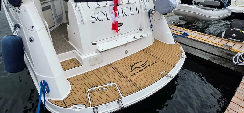  Yacht Photos Pics 2007 Rinker 350 Express yacht docked, featuring teak swim platform and "Solstice II" name.