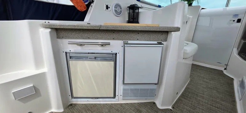  Yacht Photos Pics 2007 Rinker 350 Express yacht kitchenette with fridge and counter.