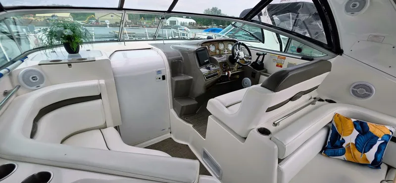  Yacht Photos Pics 2007 Rinker 350 Express boat interior with white seating, steering console, and decorative cushions.