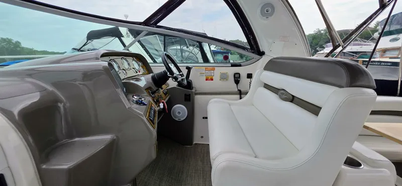  Yacht Photos Pics 2007 Rinker 350 Express boat interior with steering wheel and white seating.