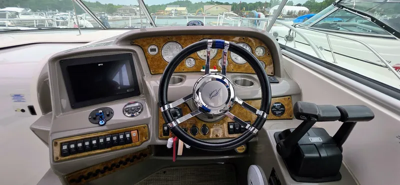  Yacht Photos Pics 2007 Rinker 350 Express helm with steering wheel, gauges, and control panel.