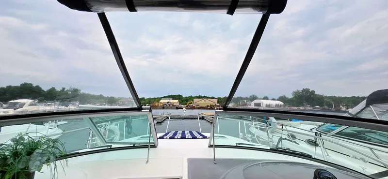  Yacht Photos Pics 2007 Rinker 350 Express boat view from cockpit, docked at marina under cloudy sky.
