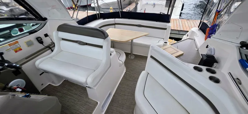  Yacht Photos Pics 2007 Rinker 350 Express boat interior with white seating and wooden table.