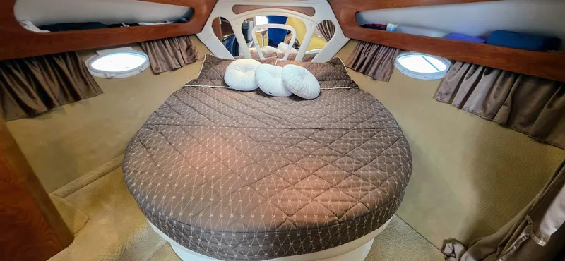  Yacht Photos Pics Luxurious cabin interior of a 2007 Rinker 350 Express yacht with a cozy bed.