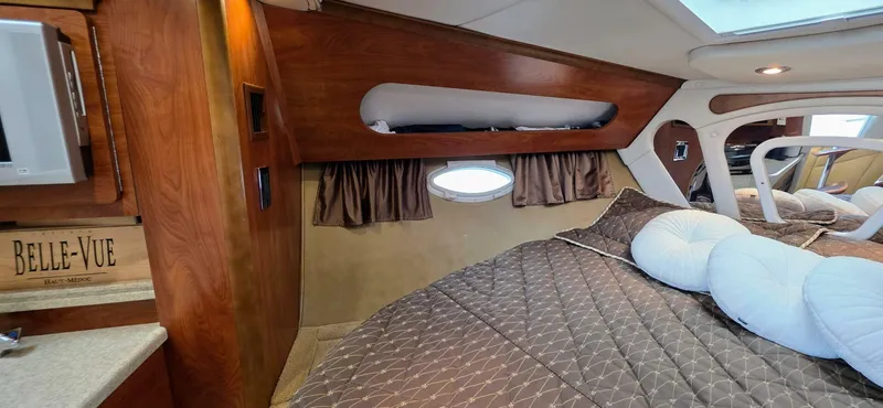 Yacht Photos Pics Luxurious interior of a 2007 Rinker 350 Express yacht with cozy bedding and wood accents.