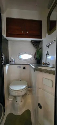  Yacht Photos Pics Compact bathroom in 2007 Rinker 350 Express yacht with toilet, sink, and storage.