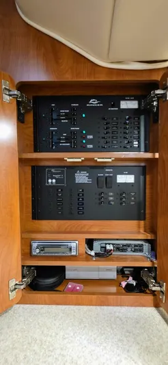  Yacht Photos Pics Electrical panel inside a 2007 Rinker 350 Express boat, featuring control switches and audio equipment.