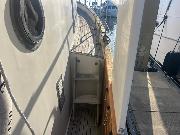 Anna Marie Yacht Photos Pics Narrow deck view of a 1987 Kadey-Krogen 42 boat with wooden steps.