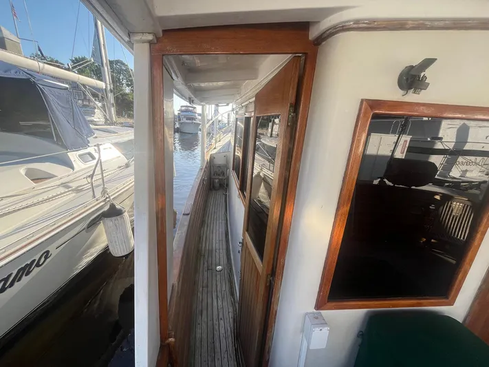 Anna Marie Yacht Photos Pics 1987 Kadey-Krogen 42 yacht deck with wooden door and marina view.