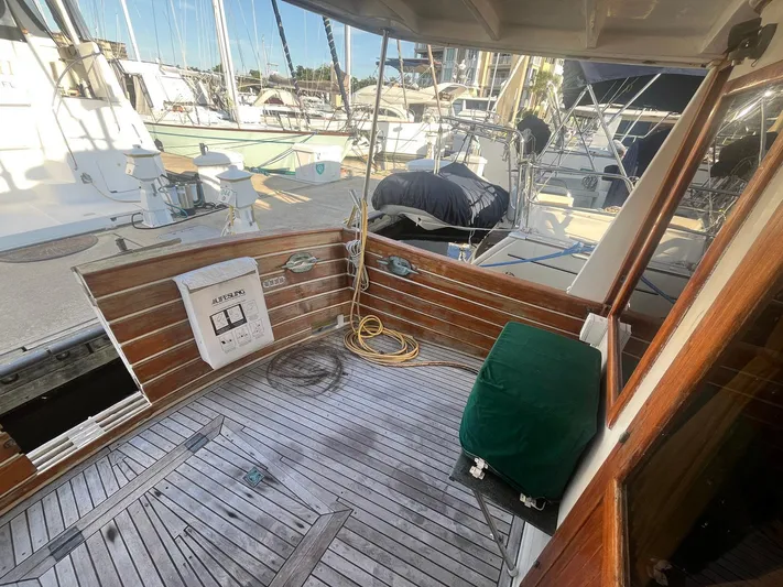 Anna Marie Yacht Photos Pics 1987 Kadey-Krogen 42 yacht deck with wooden flooring and docked boats in background.